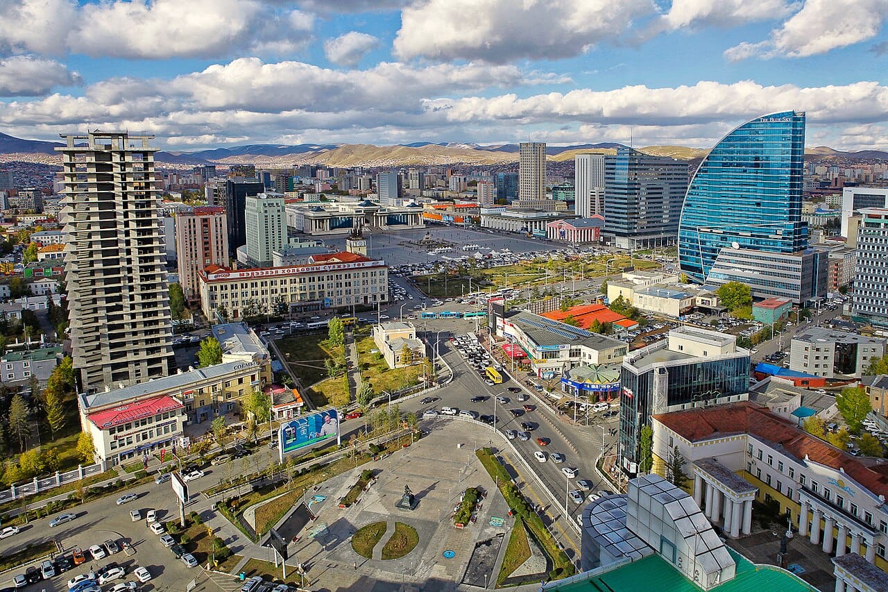 Downtown Ulaanbaatar, the capital and by far the largest city of Mongolia, where roughly half the population now lives. Its skyline of new towers, risen on the profits of the mining boom, stands in sharp contrast to the traditional herding life of the steppe.