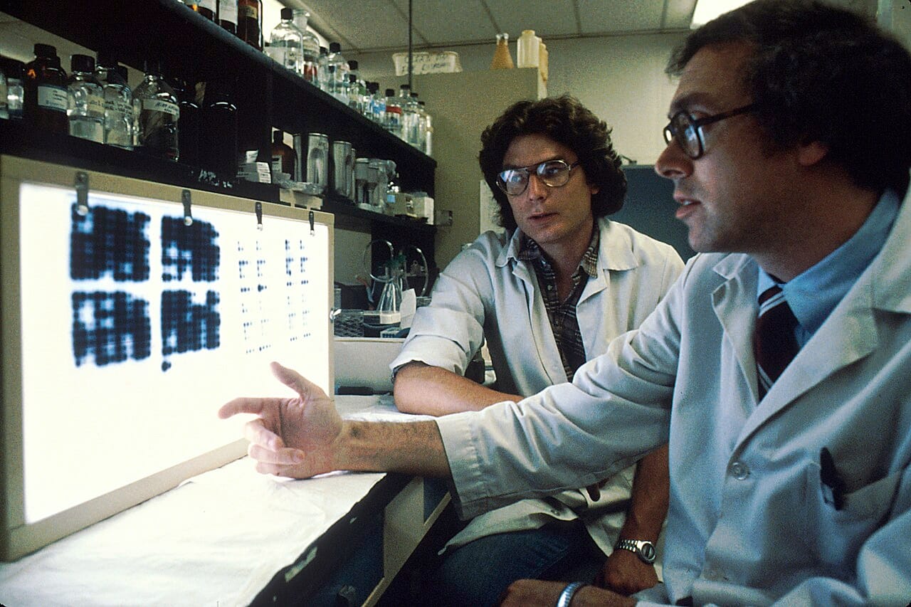 Fusing an antibody-producing cell with a cell line that divides indefinitely. The hybrid inherits both properties, which is what makes unlimited production of one antibody possible.