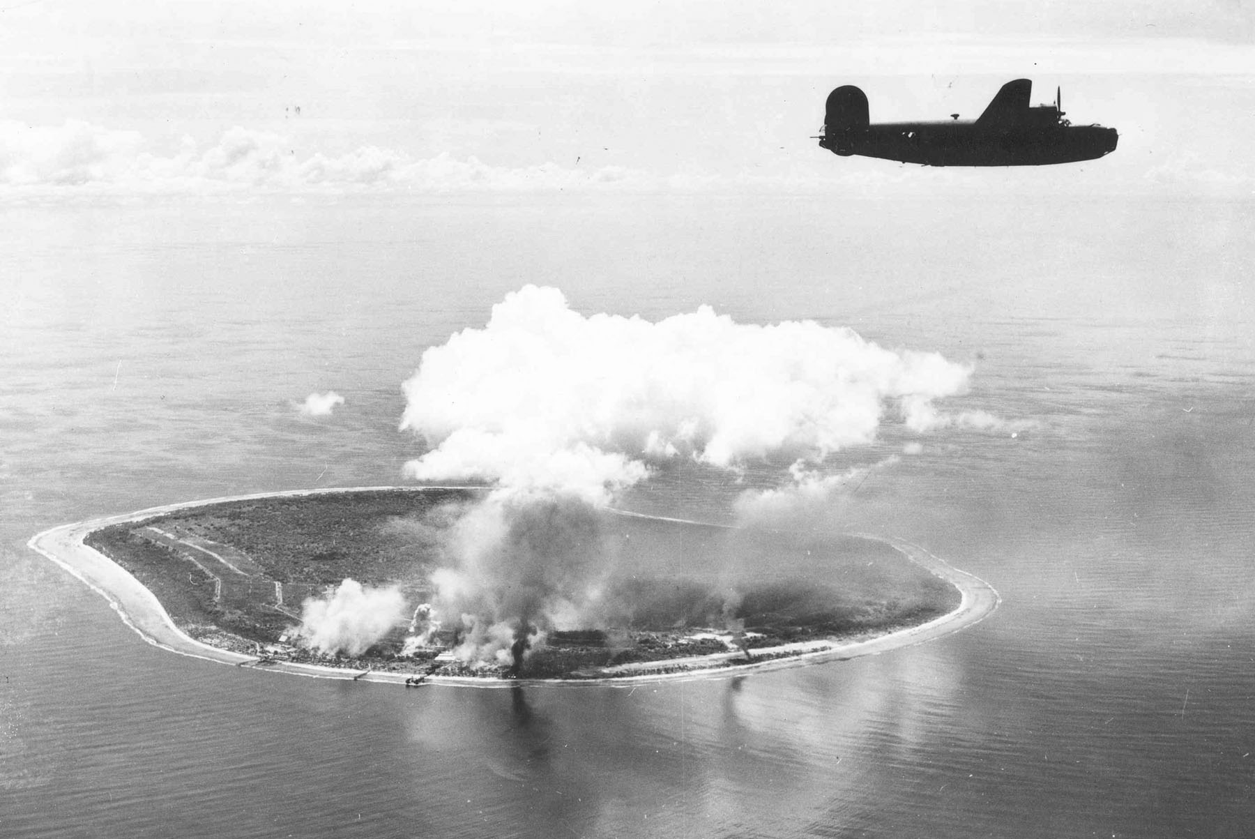 United States aircraft bombing the Japanese-held airstrip on Nauru during the Second World War. Japan's occupation brought heavy Allied bombing and the deportation of more than a thousand Nauruans to distant islands, where many perished.
