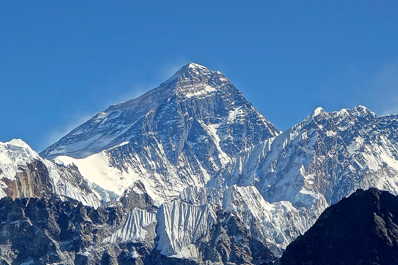 Mount Everest, at nearly nine kilometres the highest mountain on Earth, on Nepal's northern border with Tibet. Eight of the world's ten highest peaks stand within Nepal, drawing climbers and trekkers from around the globe.