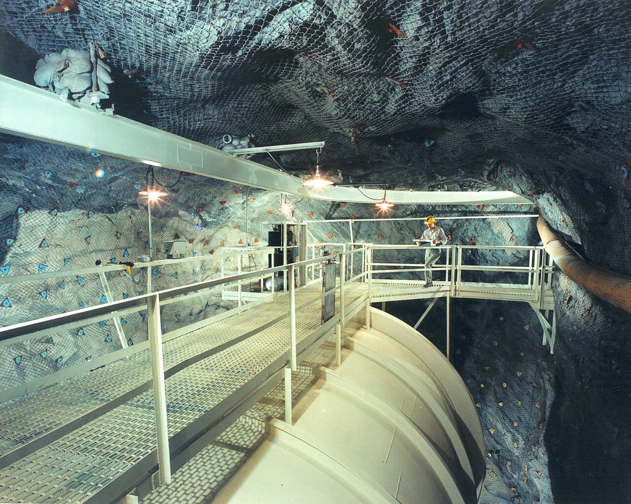 The Homestake experiment, a tank of cleaning fluid a mile underground. It counted roughly a third of the electron neutrinos the Sun was predicted to produce, and the discrepancy stood for thirty years.