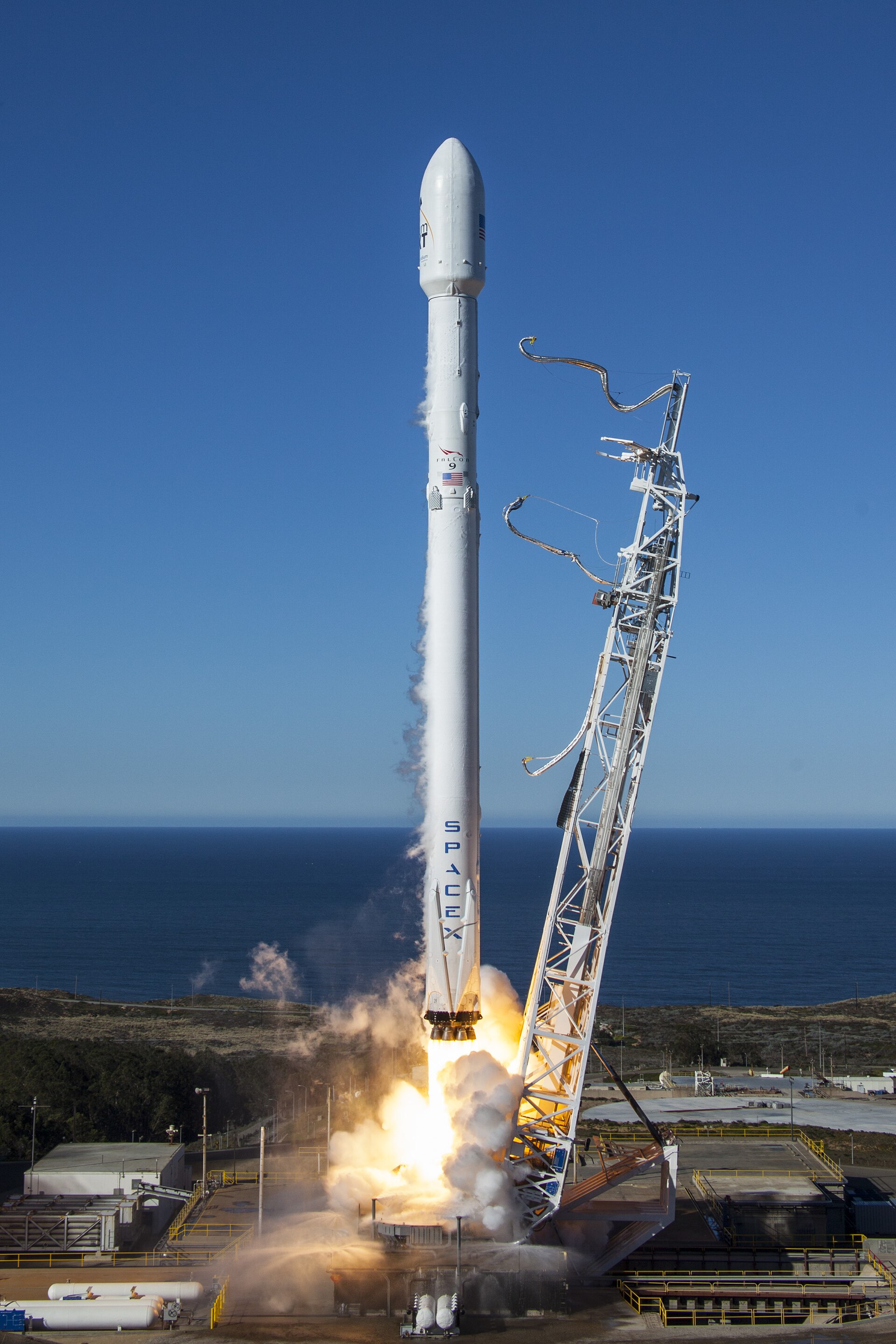 A rocket rises by the third law: pushing gas down pushes the rocket up.