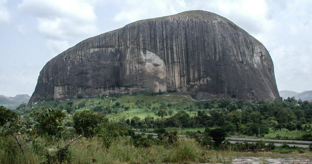 Zuma Rock, a vast monolith near the capital, Abuja. Rising some 300 metres from the plain, it is a national landmark and appears on the country's currency.