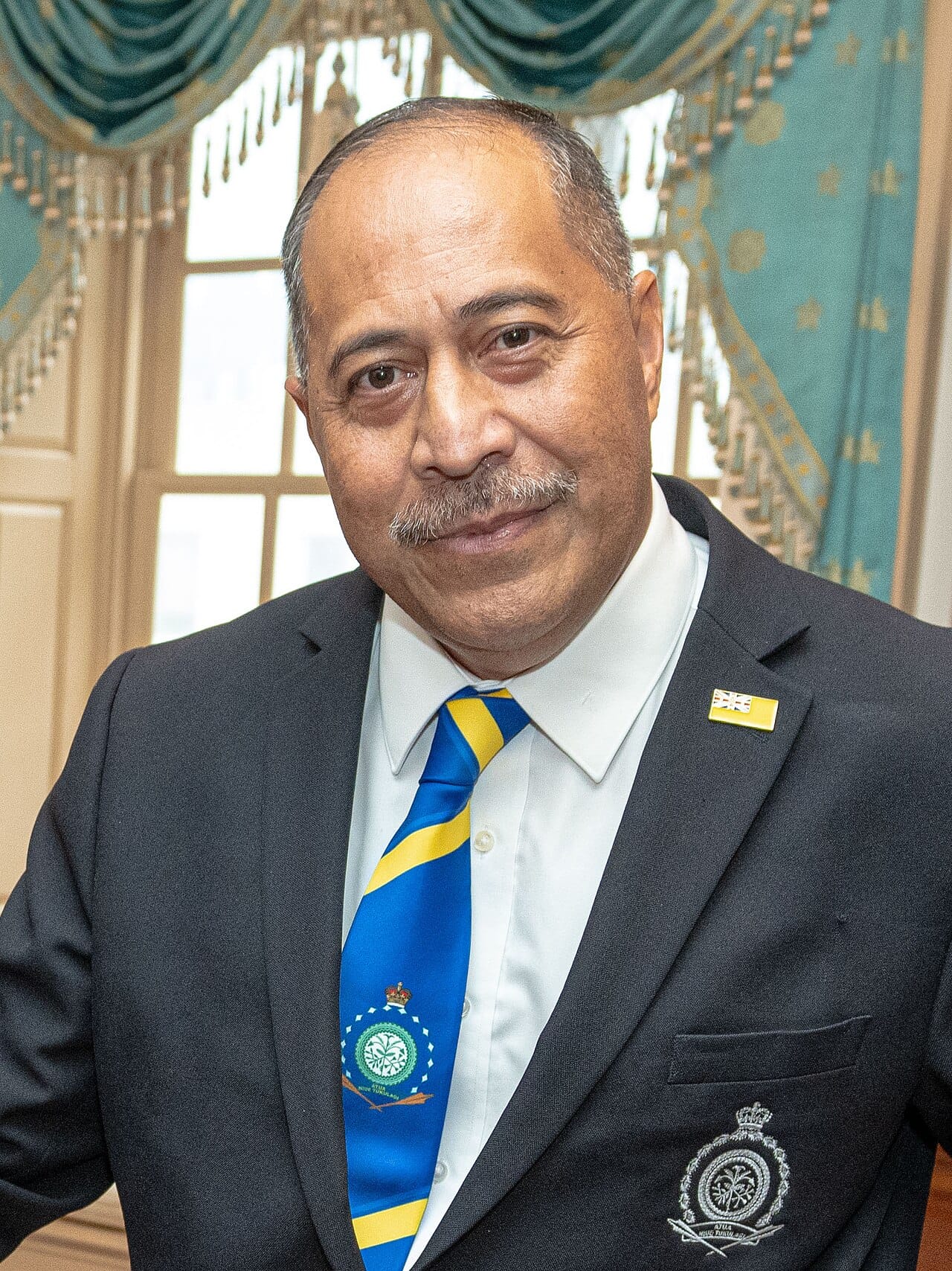 Dalton Tagelagi, premier since 2020. Niue has kept a deliberately steady relationship with New Zealand, declining to pursue a separate passport at a time when the Cook Islands was testing that question.