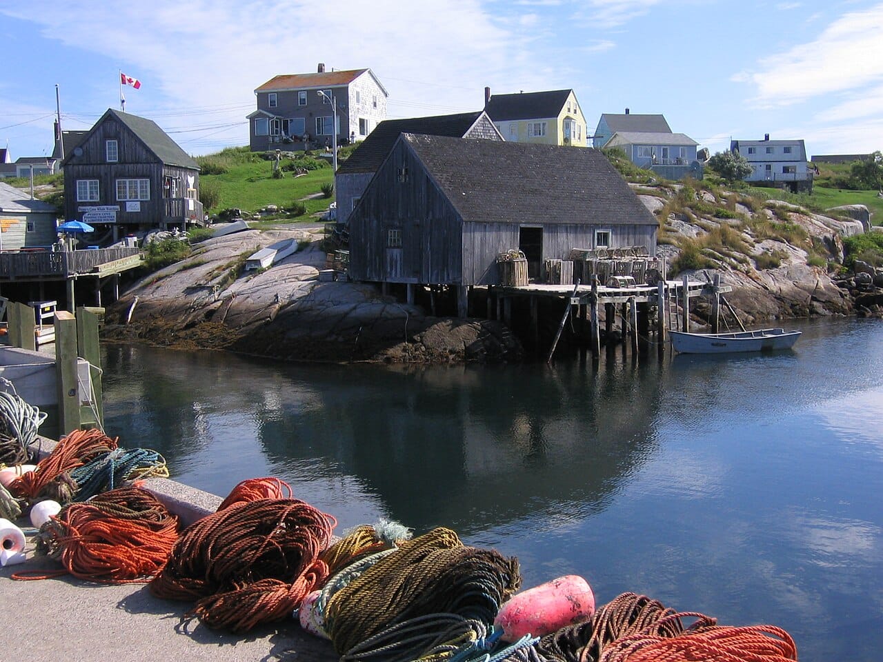 The lighthouse at Peggys Cove, standing on wave-worn granite on the Atlantic shore. The tiny fishing village is one of the most photographed spots in Canada and an emblem of the province's rugged coast.