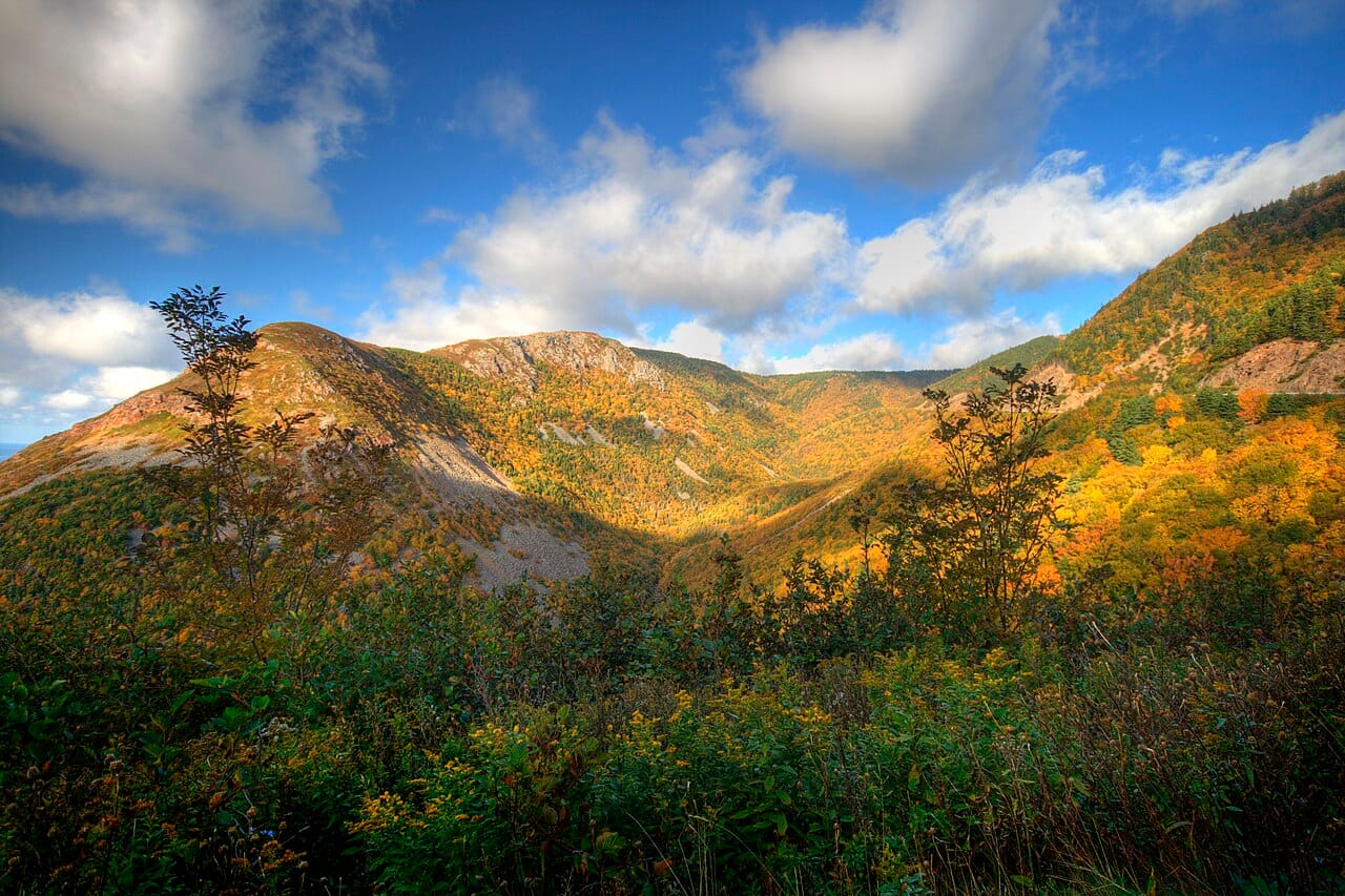 The highlands of Cape Breton Island, where the famous Cabot Trail winds along the coast. The island's rugged mountains and cliffs are among the most beautiful landscapes in eastern Canada.