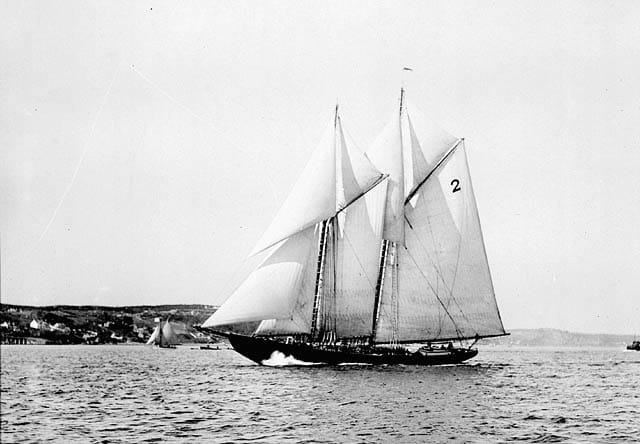 The schooner Bluenose under sail in the 1920s, a champion racer and fishing vessel from Lunenburg. A symbol of Nova Scotia's seafaring heritage, it is depicted on the Canadian ten-cent coin.