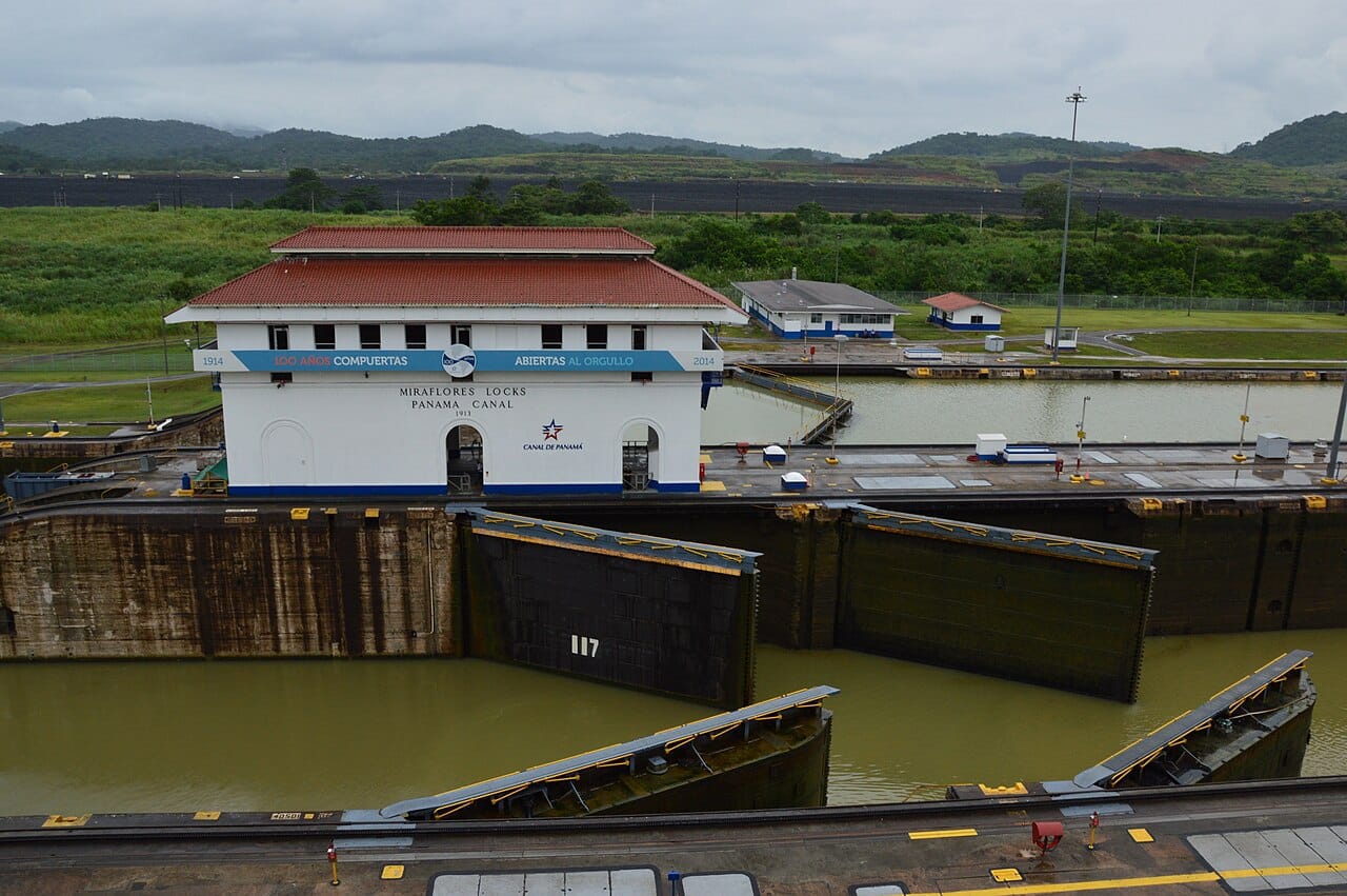 A ship passing through the Miraflores Locks on the Panama Canal. The locks lift vessels over the continental divide between the oceans; the canal carries much of the world's shipping and is the heart of Panama's economy.