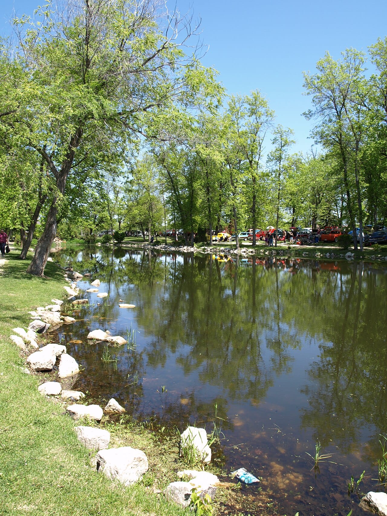 Portage la Prairie's streetscape. Crescent Lake, an oxbow of the Assiniboine, wraps around the city centre and forms the setting for much of its public space.
