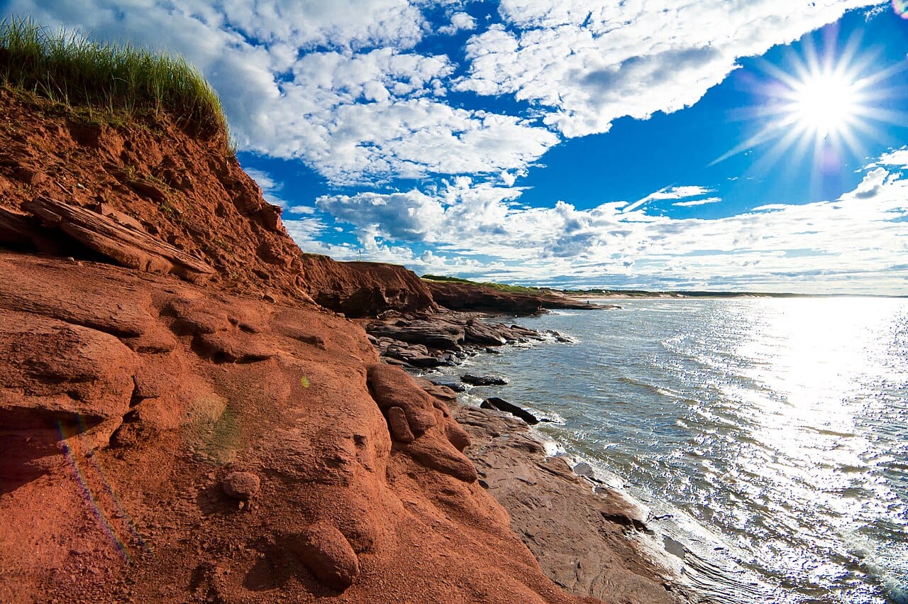 The famous red earth of Prince Edward Island, stained by iron oxide and exposed along its shores and fields. The red soil is a symbol of the island and the foundation of its potato farming.