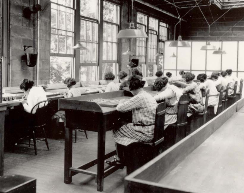 Dial painters at work. Instructed to shape their brushes with their lips, they ingested radium daily, and their litigation established that employers could be held liable for occupational disease.