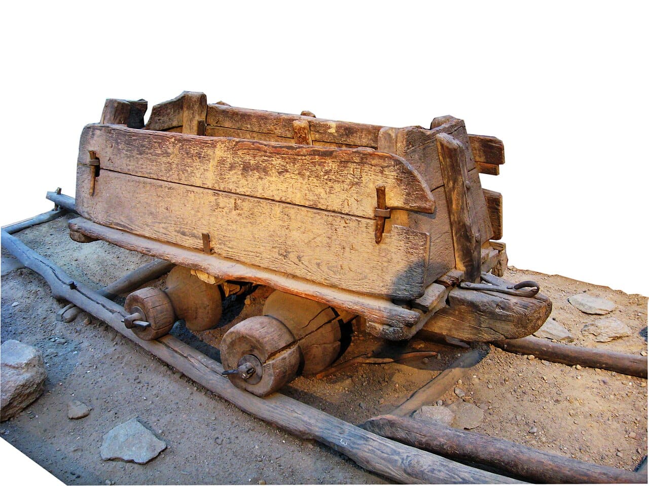 A wooden waggonway. Guided tracks were used in mines for centuries before steam, because a smooth hard rail lets an animal pull far more than a road allows.