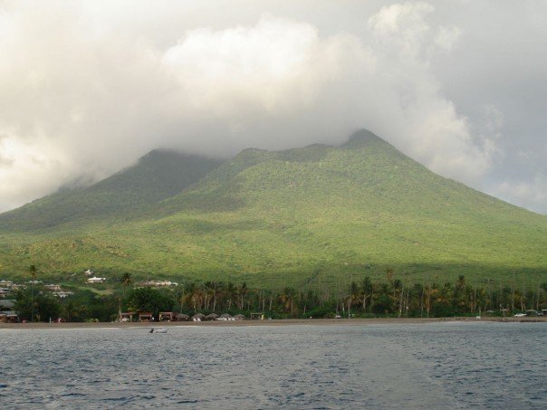 Clouds wreathing Nevis Peak, the volcanic summit that forms the smaller island of the federation. Credit: Jensonmorton at English Wikipedia (Public domain).