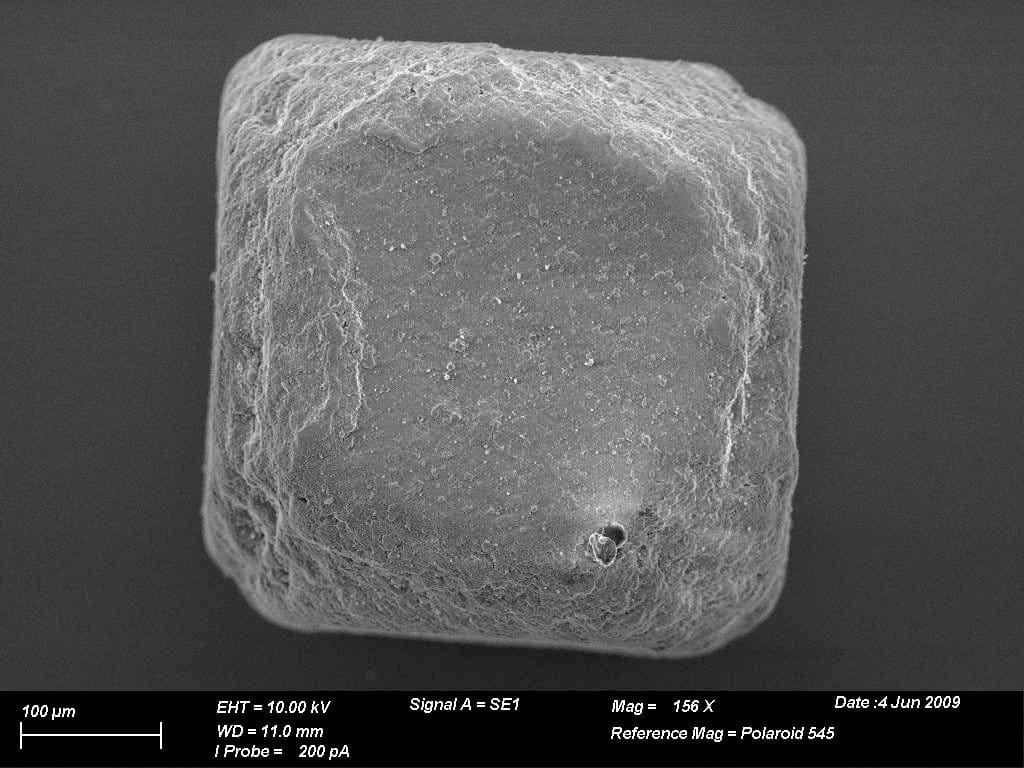 A grain of table salt under an electron microscope. The cubic crystal reflects the arrangement of sodium and chloride ions in the lattice.