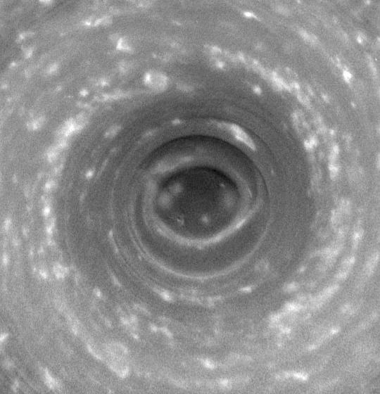 A swirling, hurricane-like vortex at Saturn's north pole, set within a strange six-sided cloud pattern. Credit: NASA/JPL/Space Science Institute (Public domain).