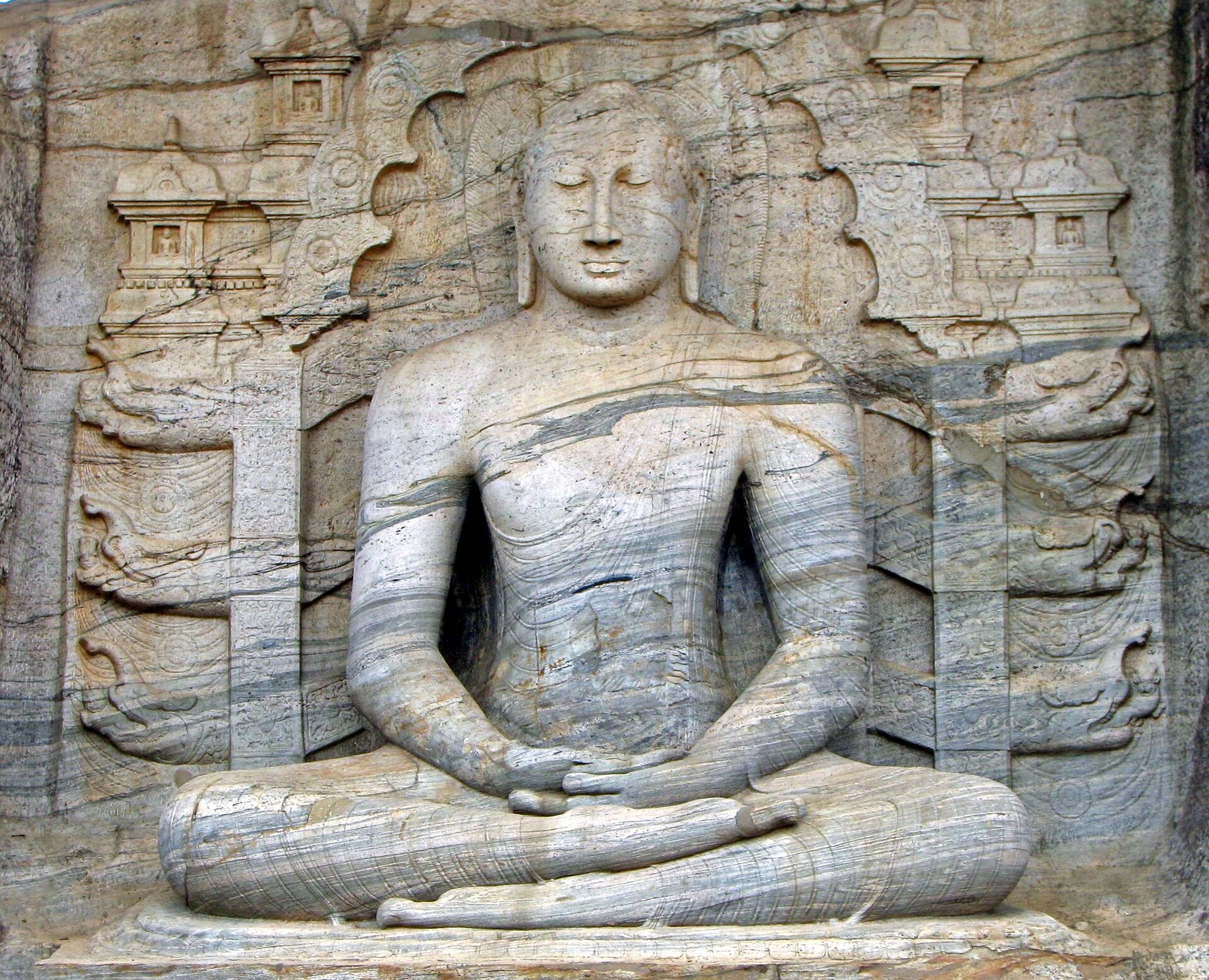 The Gal Vihara at Polonnaruwa, a group of Buddha images carved from a single granite face in the twelfth century. The serene reclining and standing figures are among the finest works of Sinhalese sculpture.