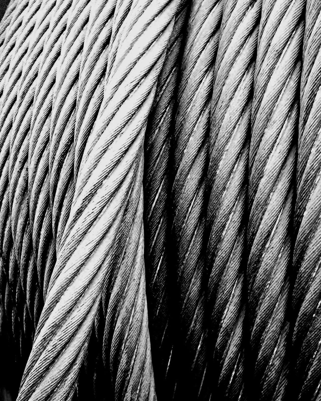 Steel wire rope. The same material serves in forms from thin drawn wire to heavy structural sections, which is part of why it displaced alternatives so completely.
