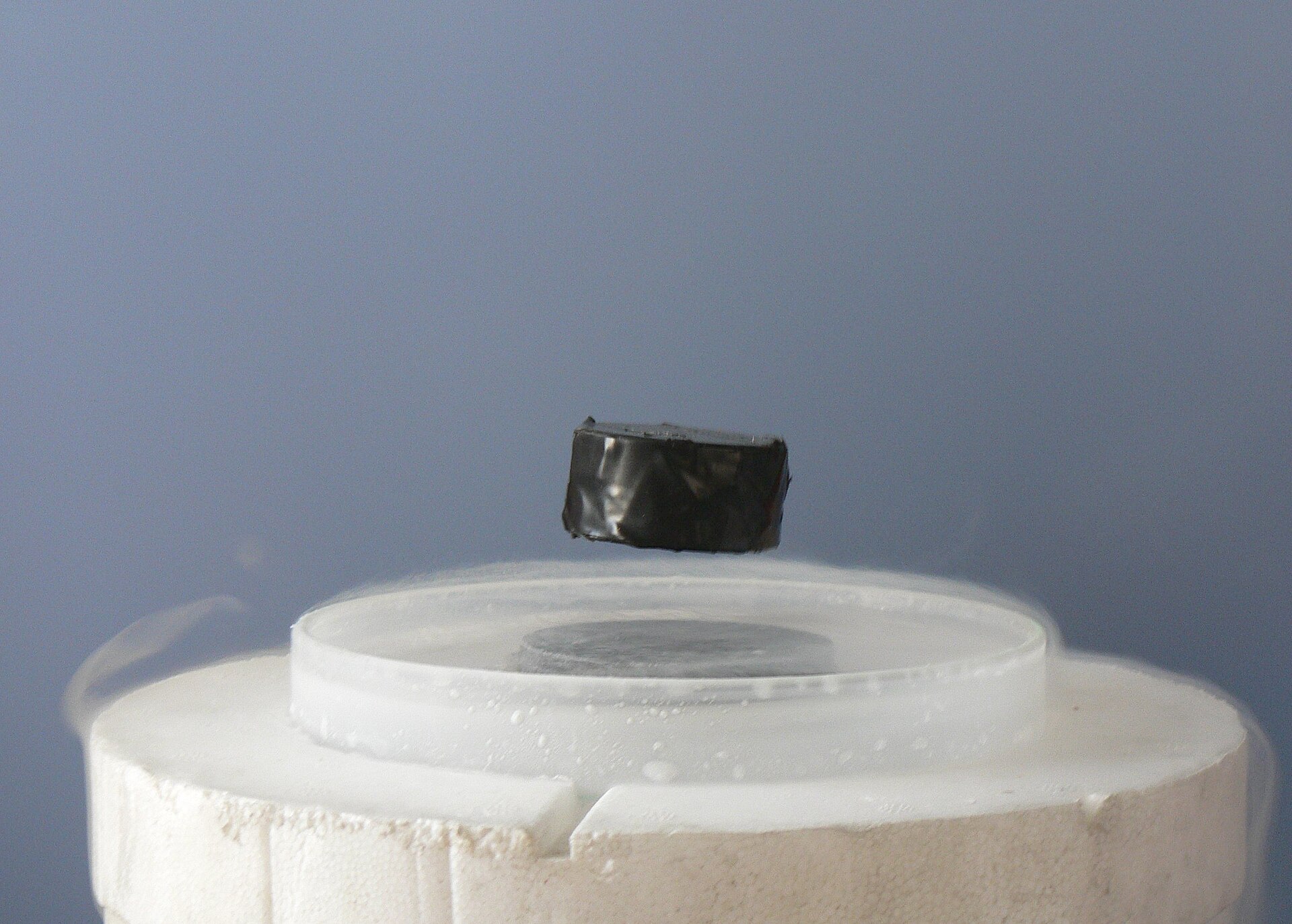 A magnet levitating above a superconductor; ideas from string theory now reach into condensed matter physics.
