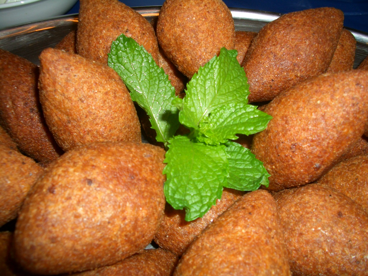 Kibbeh, a dish of bulgur wheat and minced meat that is often called a national speciality of Syria. Shaped into stuffed ovals and fried, baked, or served raw, it is a centrepiece of the Levantine table.