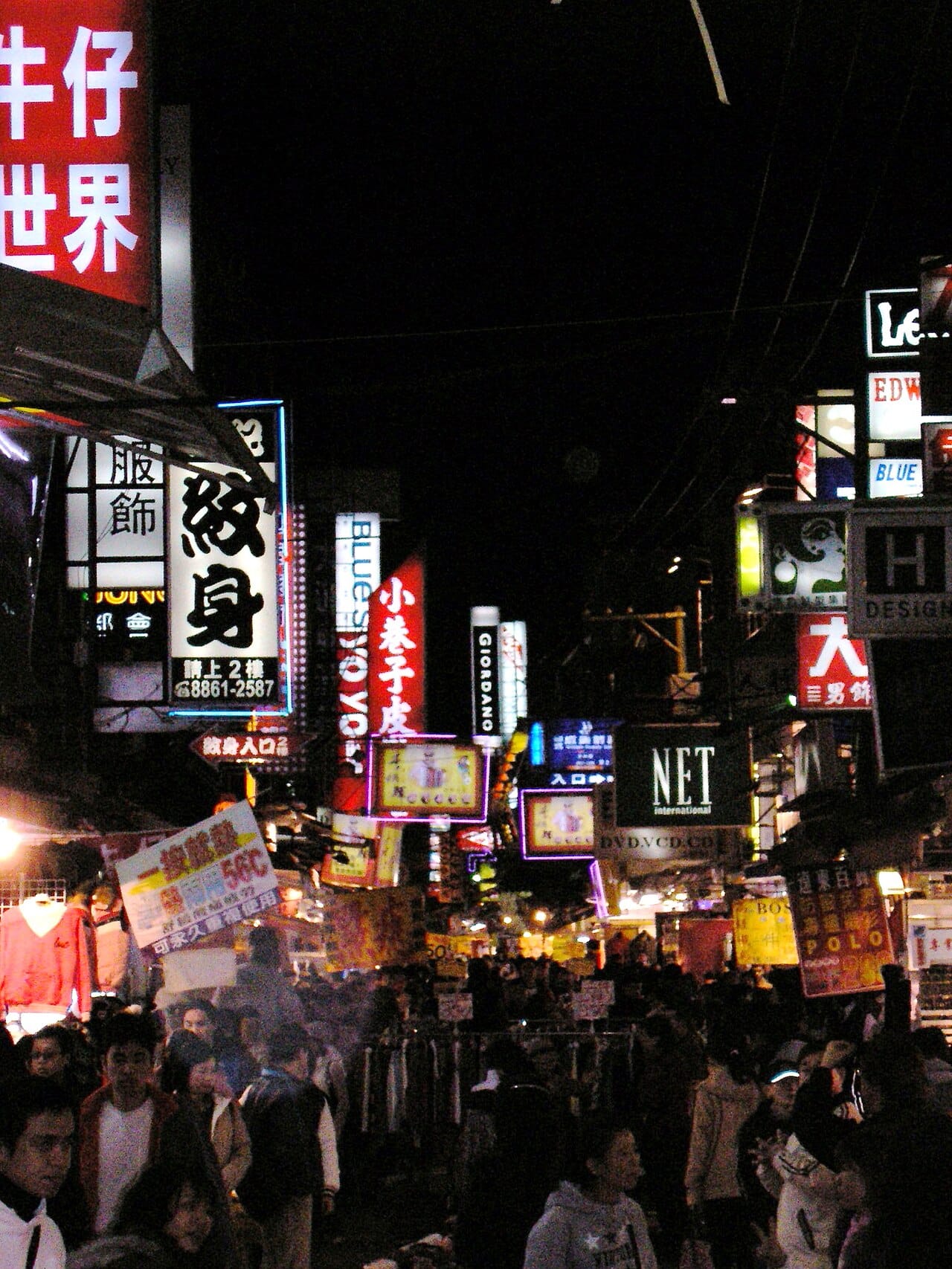 An alley in Shilin night market, Taipei. Night markets are where much of Taiwan eats and socialises, selling small dishes stall by stall, and they are as much a social institution as a source of food.