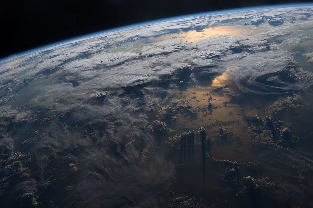 Cloud from orbit. The troposphere holds nearly all the water vapour and all the weather, and its depth is a fraction of one per cent of the planet's radius.