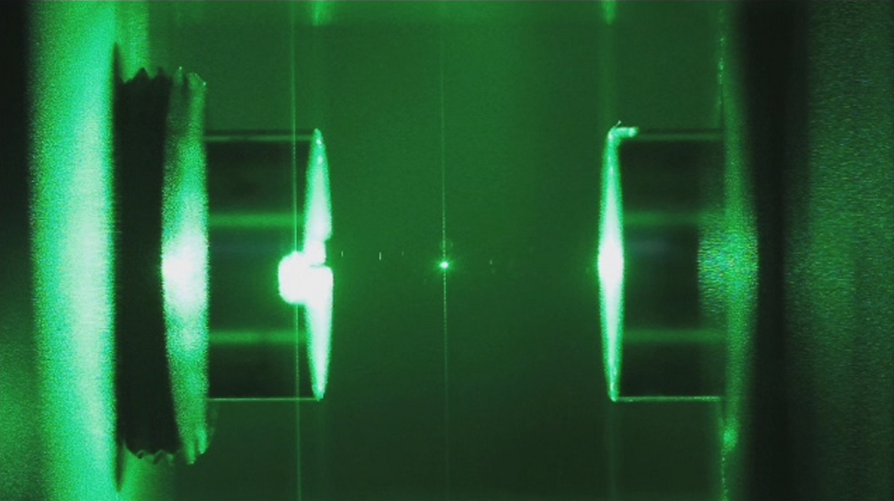 Light confined in an optical cavity. Mirrors at each end return photons through the gain medium repeatedly, which is what builds a coherent beam rather than a bright glow.