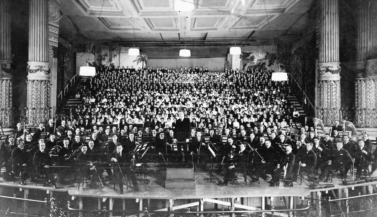 A very large orchestra assembled for a Mahler premiere. Nineteenth century composers wrote for progressively larger forces, and the instrumentation of the standard orchestra reflects that period.