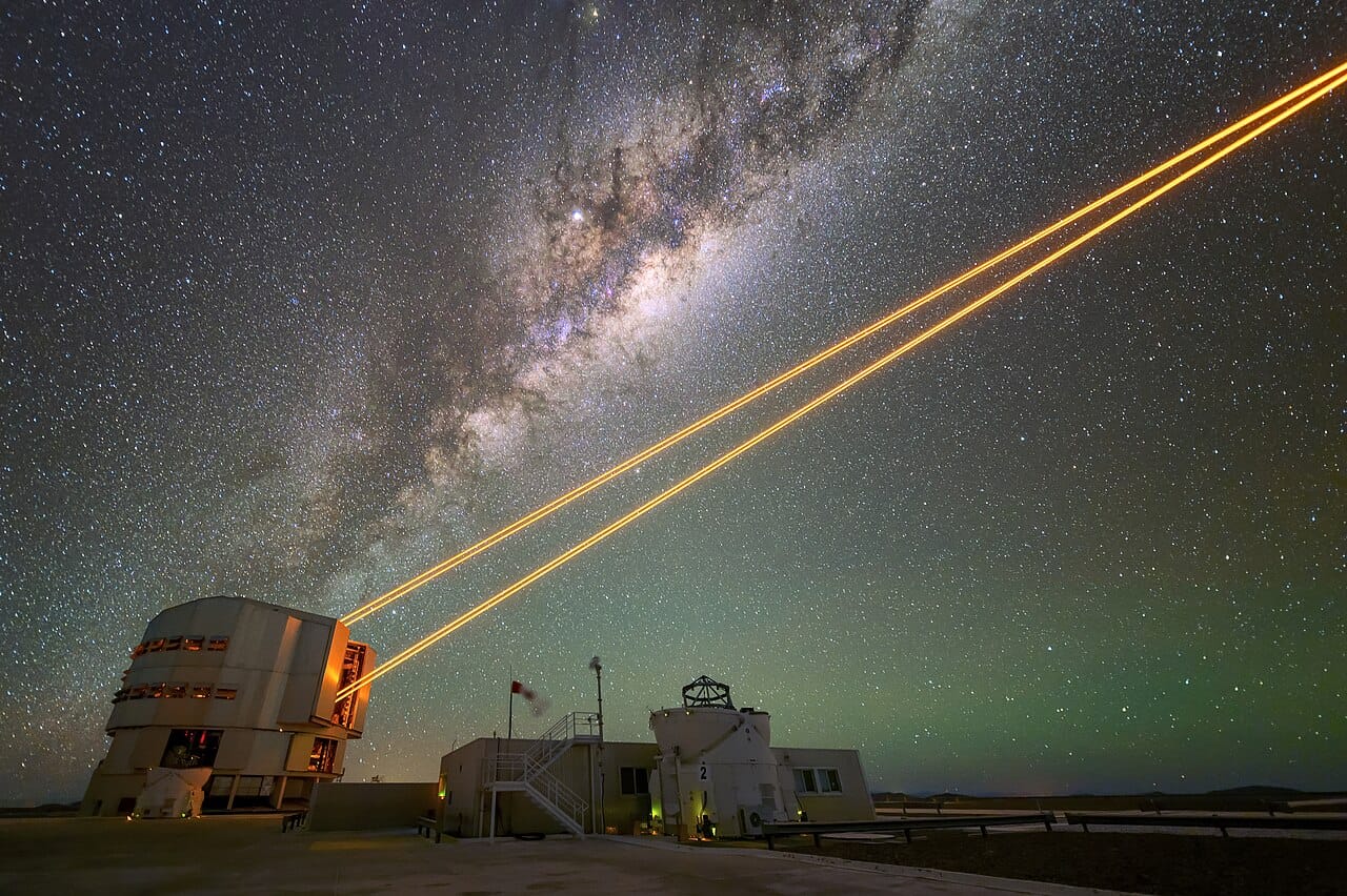 A laser guide star projected into the atmosphere. Coherent light of a single frequency, produced by stimulated emission, is used to measure and correct atmospheric distortion.