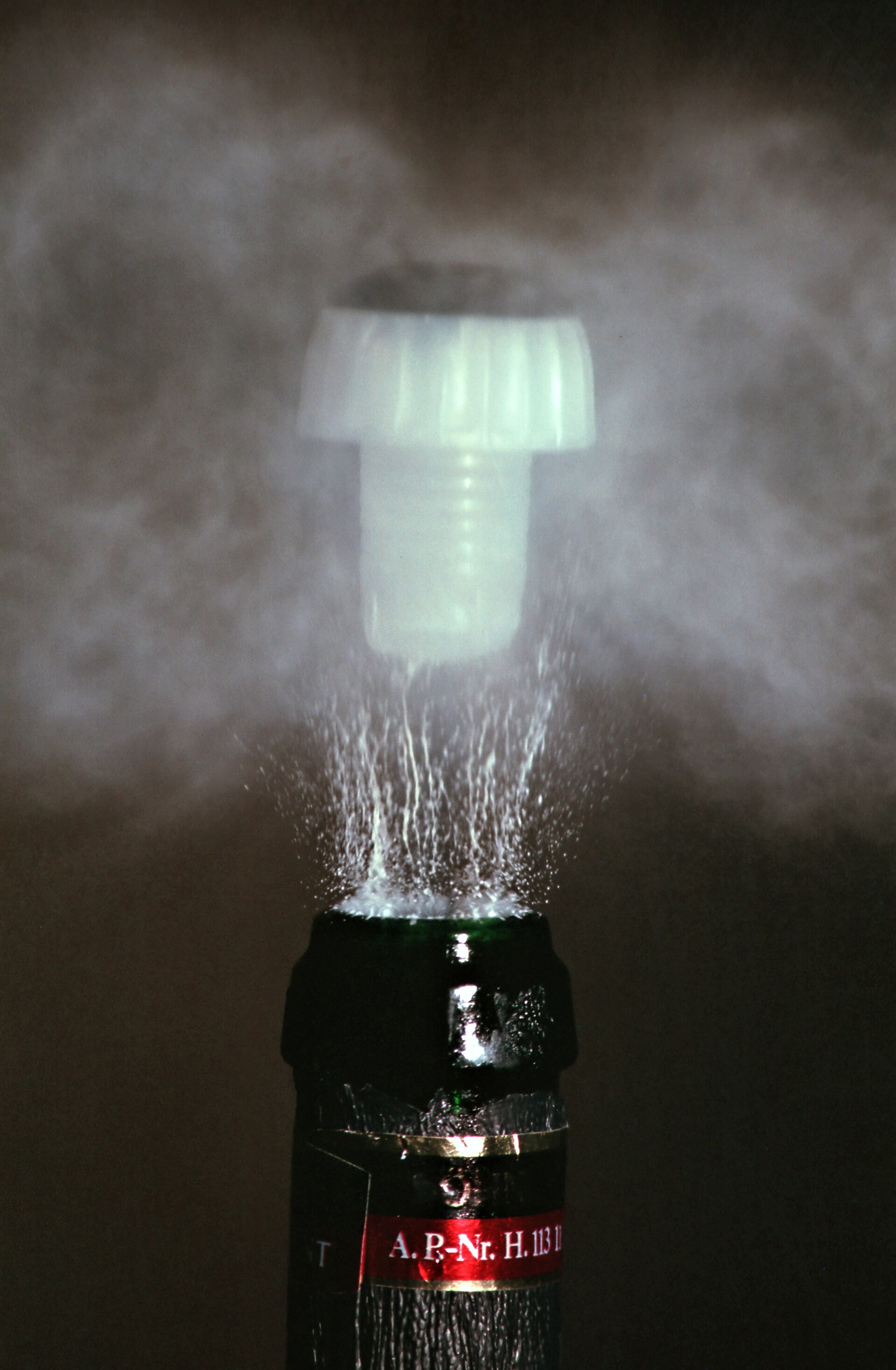 Gas escaping a bottle, a vivid example of energy and expansion in action.