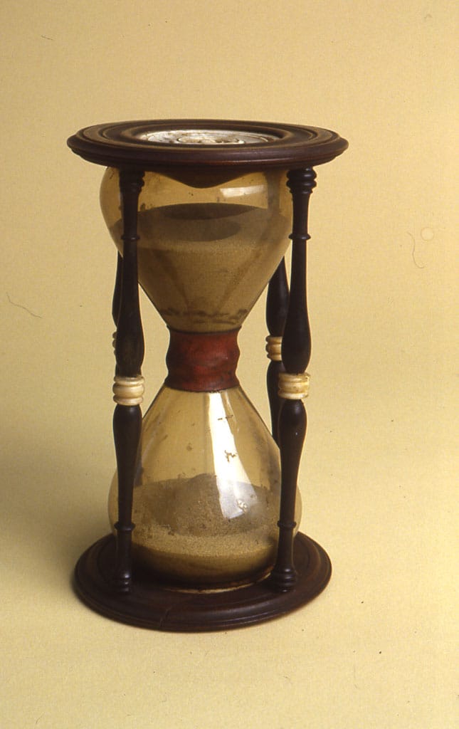 An hourglass. Devices measuring an interval rather than telling the time were used where a fixed duration mattered, including at sea and in ritual.