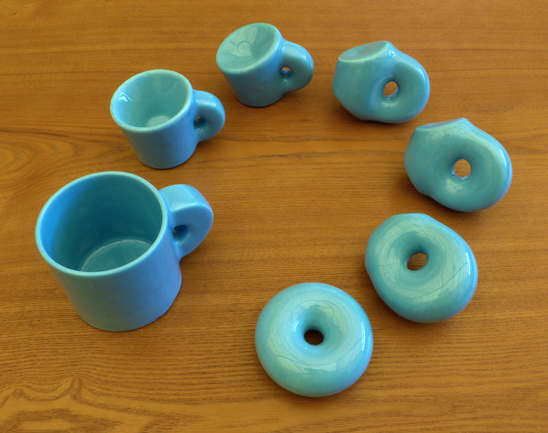 A continuous deformation turning a coffee mug into a doughnut, the classic topology example.
