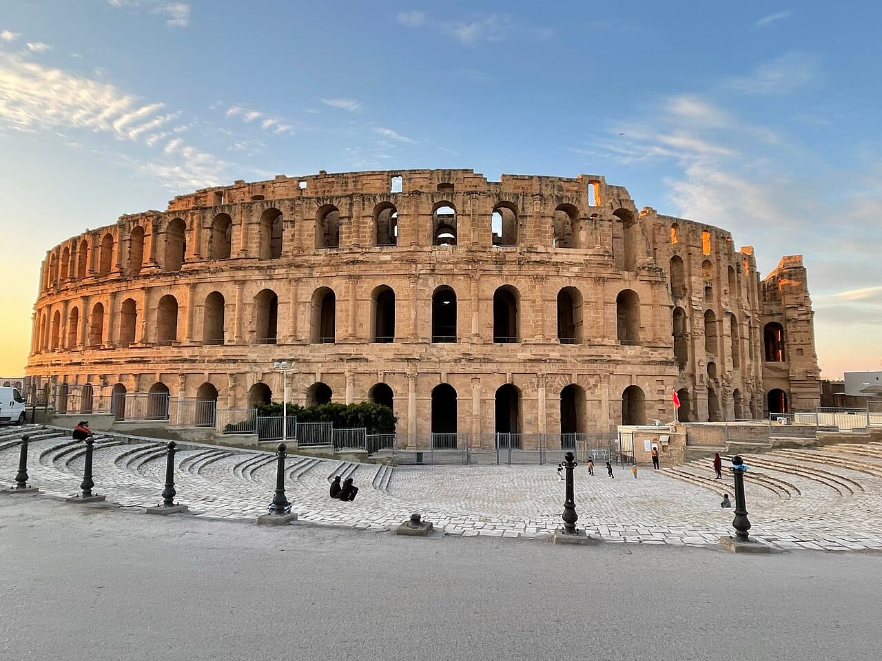 The amphitheatre at El Djem, built around AD 238 and holding an estimated 35,000 spectators. It stands in a town that could never have filled it, a reminder of the extraordinary wealth that grain and olive oil brought to Roman Africa.