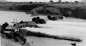 The construction of the Owen Falls Dam at Jinja, near where the Nile begins its journey from Lake Victoria. Credit: unknown, but since this is a postcard image, it was created and published in Uganda (Public domain).