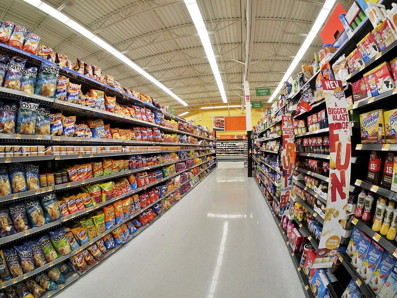 An aisle of packaged foods. The category was defined to capture industrial formulations rather than any particular nutrient, which is what made it new and what makes it contested.