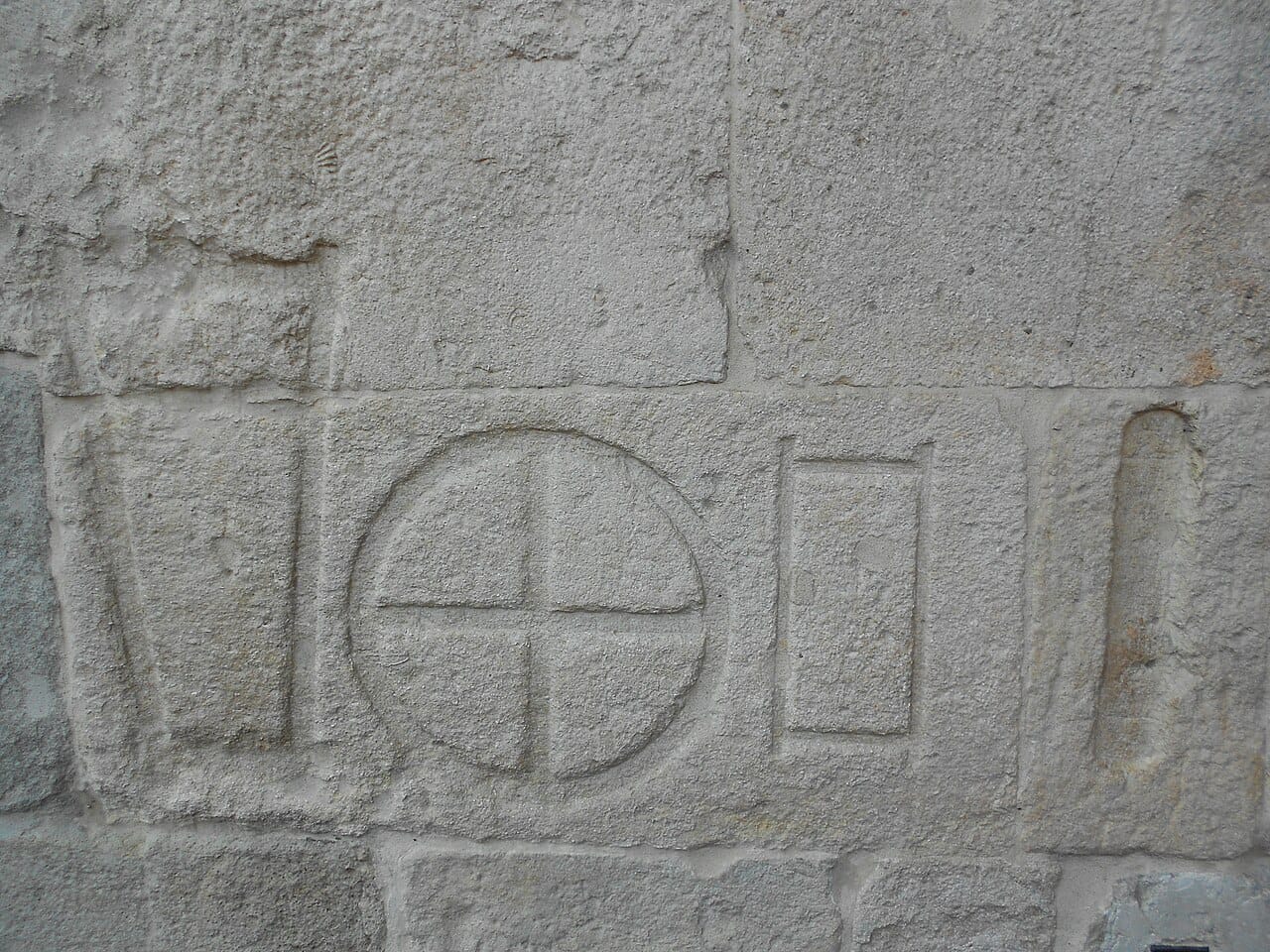 Standard measures cut into stone in a public place. Displaying the official standard publicly allowed anyone to check a measure against it.