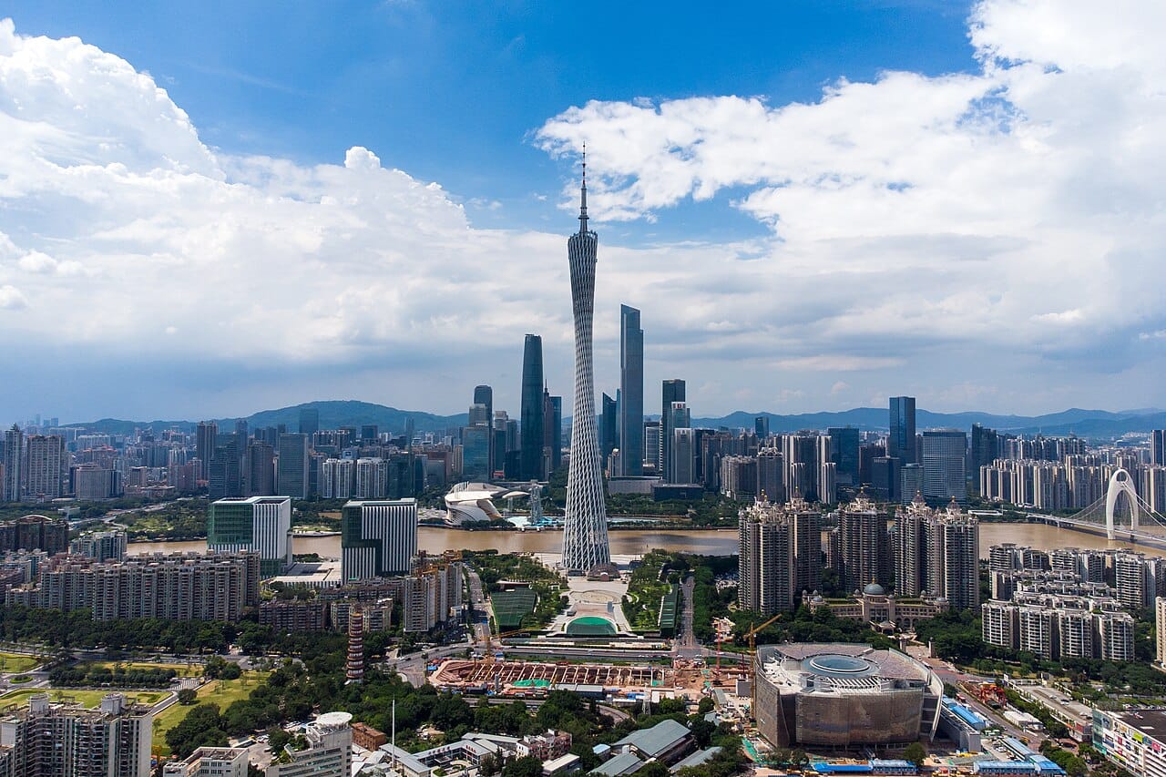 A rapidly built commercial district. Urban density concentrates economic activity and requires infrastructure that takes far longer to build than buildings do.