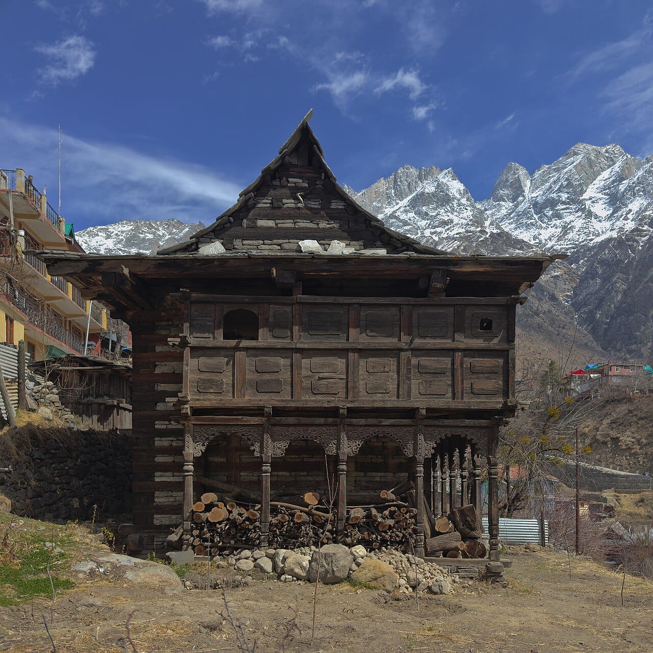 A house in the Indian Himalaya. Timber and stone construction with small openings and compact form retains heat where winters are severe.