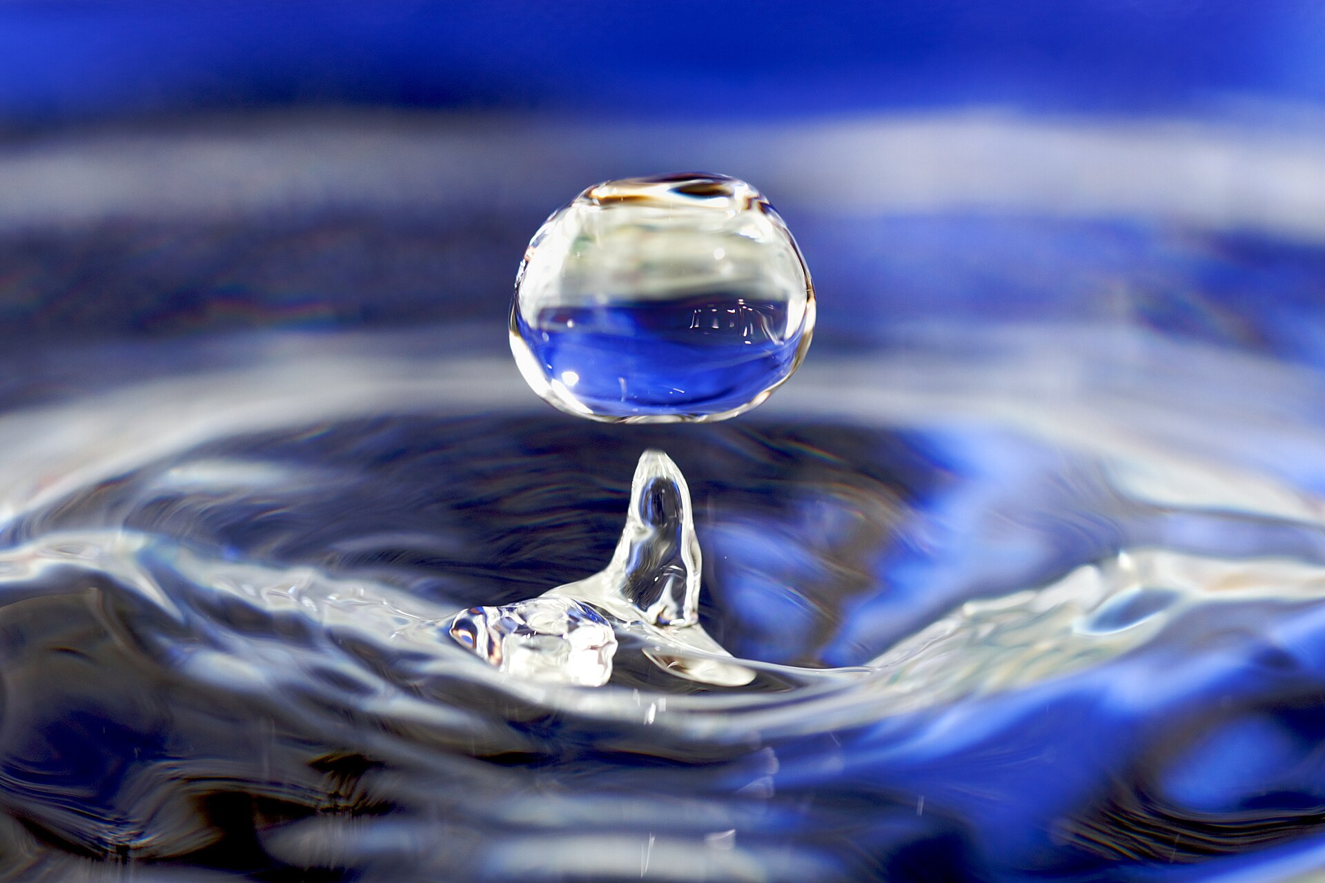 A drop of water falling toward water in a glass Credit: José Manuel Suárez from Spain (CC BY 2.0).