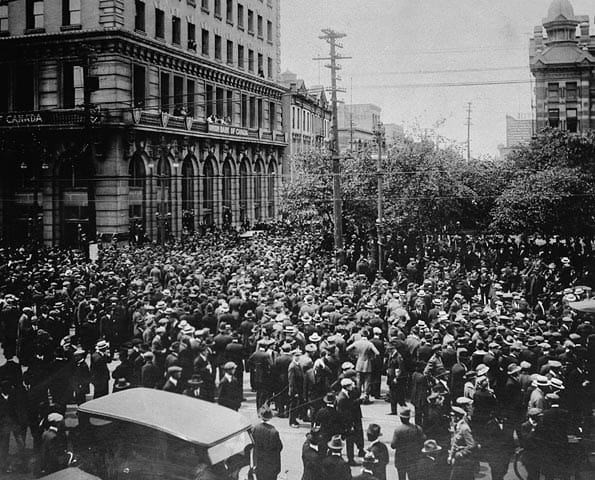 Crowds during the Winnipeg General Strike of 1919. A streetcar was overturned and burned on what became known as Bloody Saturday, when the Royal North West Mounted Police charged the crowd; two men died.