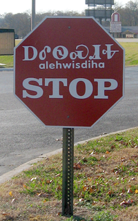 A stop sign in Cherokee. Sequoyah devised the Cherokee syllabary in the 1820s without being able to read English, an achievement with few parallels.