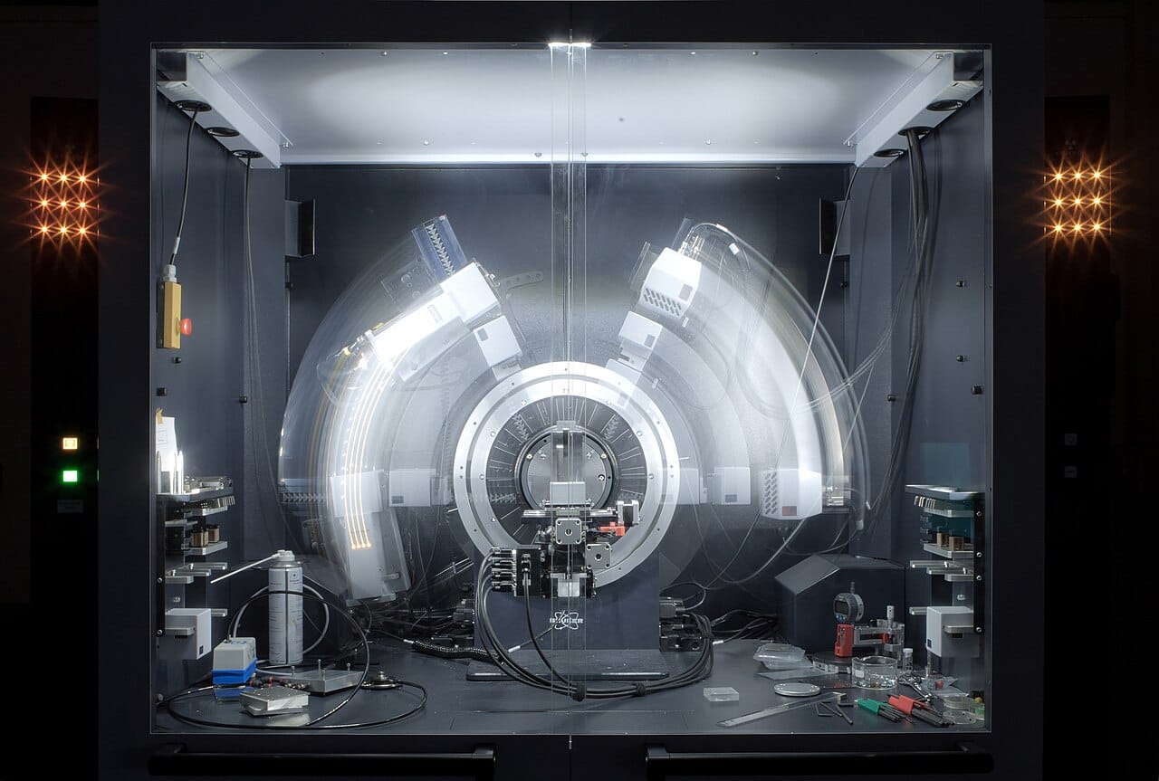 A crystal mounted for diffraction measurement. Each spot in the resulting pattern encodes a spacing within the lattice; recovering the structure means combining thousands of them.
