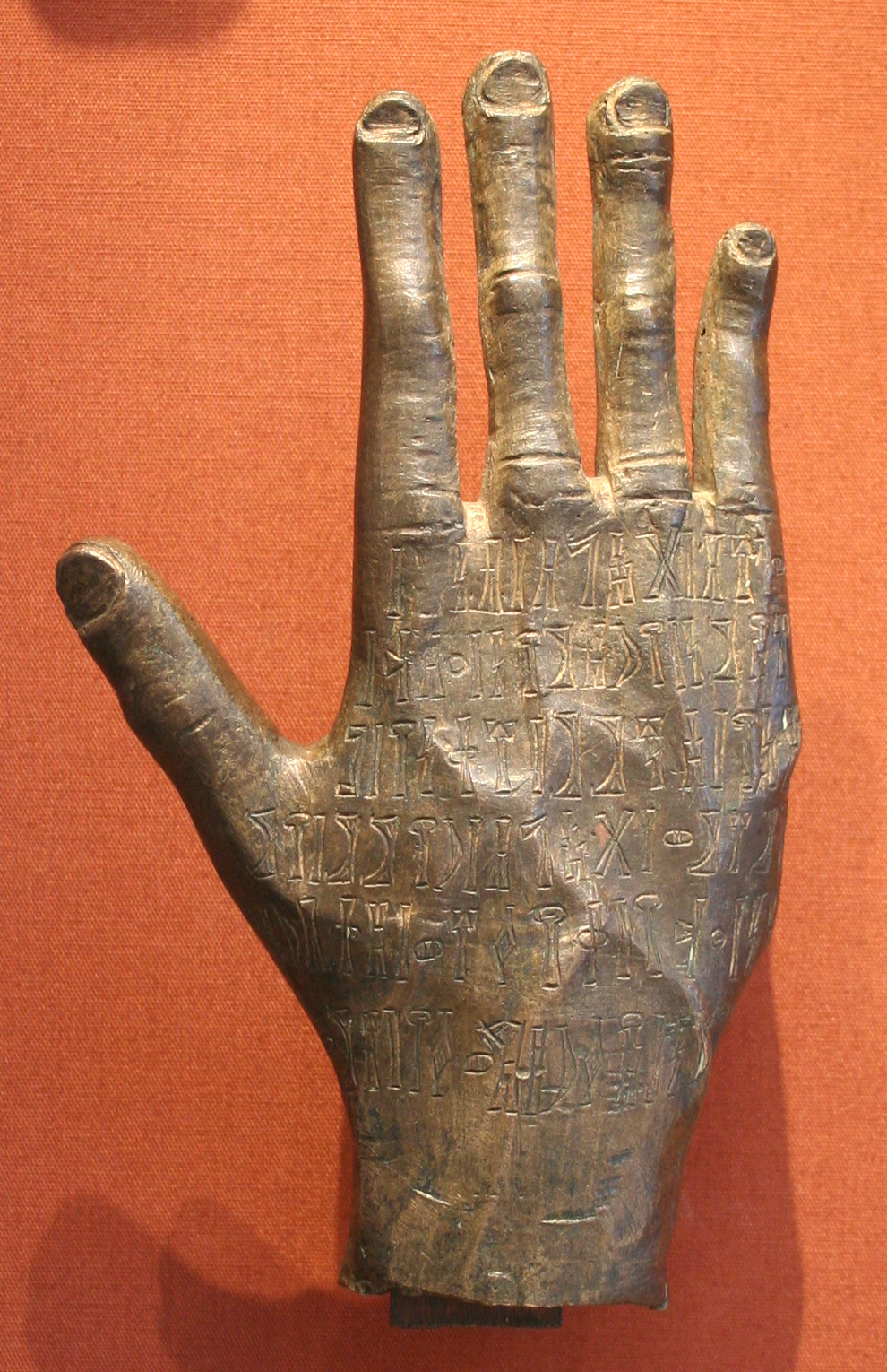 A bronze votive hand inscribed with a prayer in the ancient South Arabian script, offered to a Himyarite god. Objects like this show the distinctive religion and craftsmanship of Yemen before Islam.